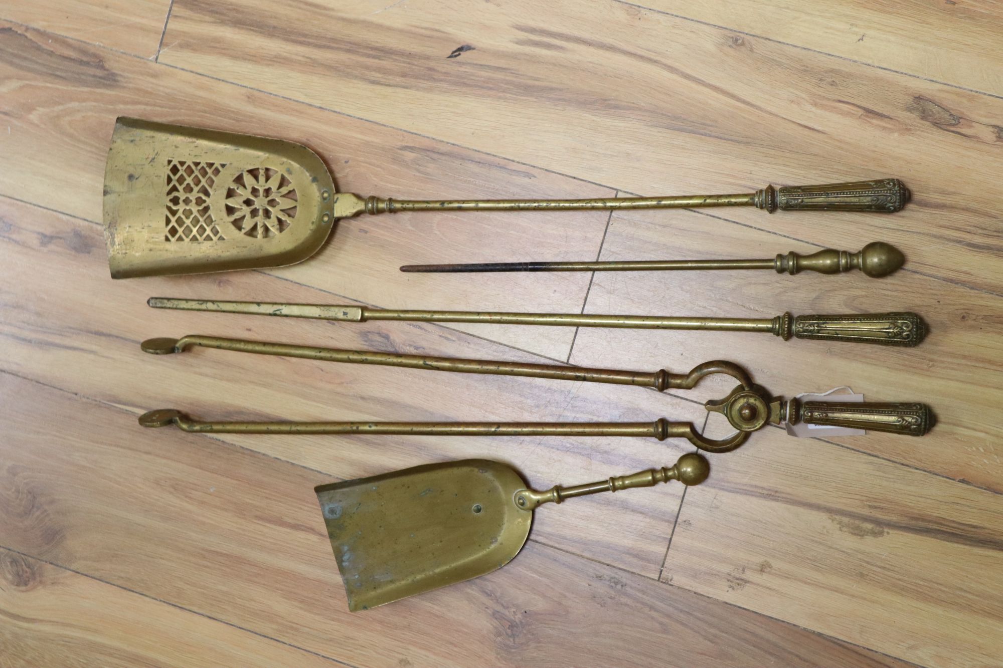 A set of three Georgian gilt bronze fire implements, a similar brass shovel and sundries,